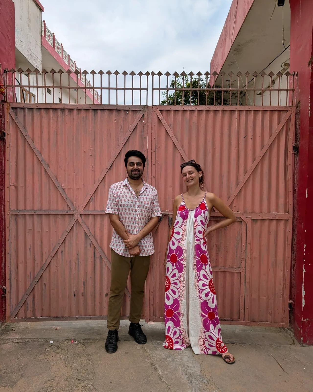 Camille and her partner at a painted gate in India